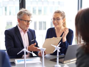 uomo e donna discutono un report in riunione